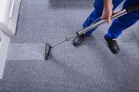Janitor's Hand Cleaning Carpet With Vacuum Cleaner